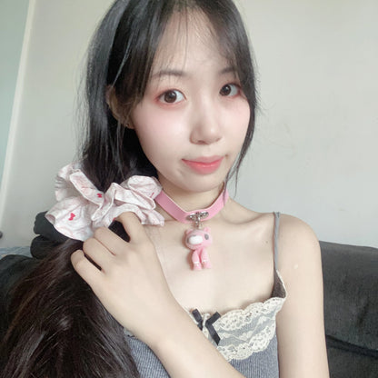 This pink choker features a cute Gloomy Bear pendant. The soft leather strap and adorable design add a sweet, edgy vibe.