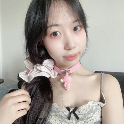 This pink choker features a cute Gloomy Bear pendant. The soft leather strap and adorable design add a sweet, edgy vibe.